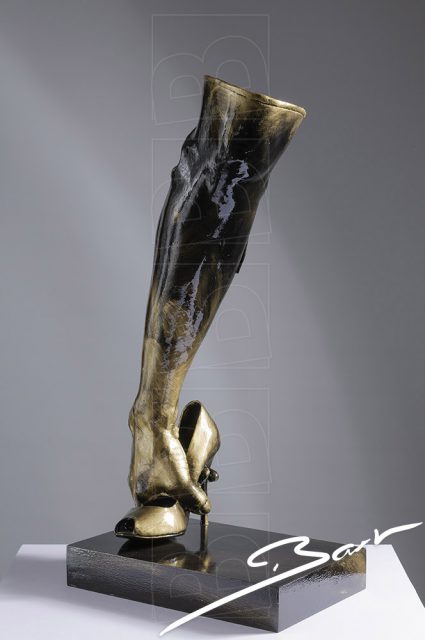 Sculpture of a boot made out of a high heeled shoe, a lady's leg and a hand
