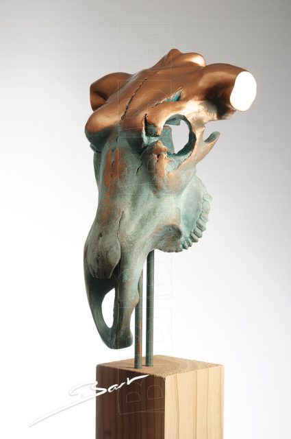 Sculpture of a skull of a bull with the appearance of the torso of a woman